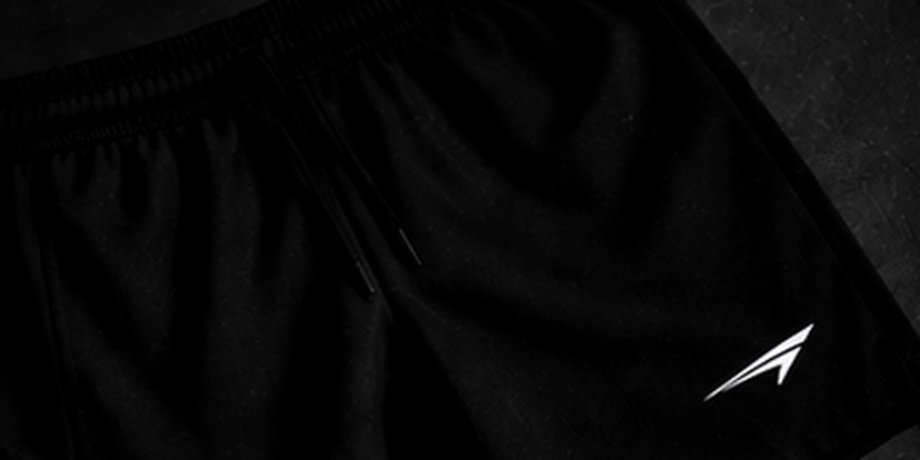 Black ACE shorts laid on turf