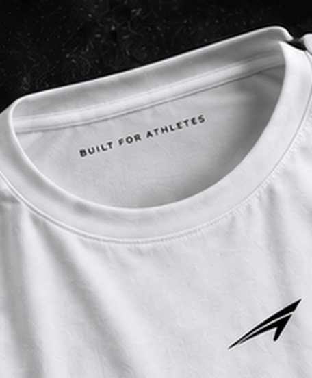 Close-up of the white tee collar with Built for athletes printed inside the neck